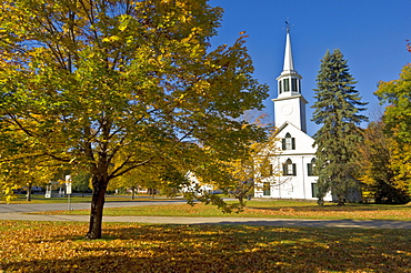 Autumn colours around traditional white timber clapperboard church, Townshend, Vermont, New England, United States of America, North America