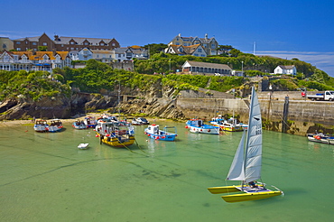 Small fishing boats and a catamaran at low tide, Newquay harbour, Newquay, Cornwall, England, United Kingdom, Europe