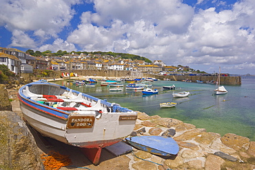 Small boat on the quay and small boats in the enclosed harbour at Mousehole, Cornwall, England, United Kingdom, Europe