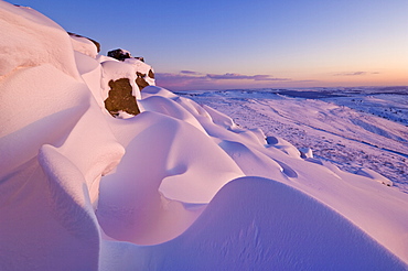 Snow covered moorland at sunset on Stanage Edge, Peak District National Park, Derbyshire, England, United Kingdom