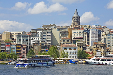 The Galeta tower (Galeta Kulesi) , a former watchtower built in 1348, Beyoglu district, with a ferry crossing the Golden Horn, central Istanbul, Turkey, Europe