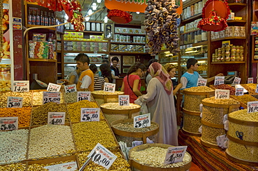 People buying pulses, nuts and spices at a stall in the Egyptian bazaar (Spice bazaar) (Misir Carsisi), Eminonu, Istanbul, Turkey, Europe