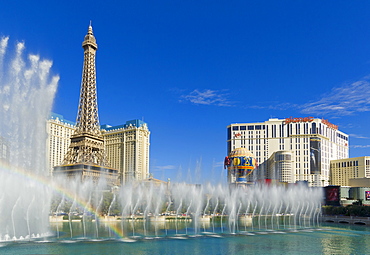 Rainbow produced by the dancing water fountains of the Bellagio hotel with Planet Hollywood hotel, and Paris Hotel with the Eiffel tower, The Strip, Las Vegas Boulevard South, Las Vegas, Nevada, United States of America, North America