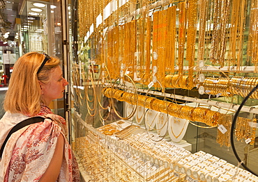 Female tourist shopping, Gold Souk Market, Deira, Dubai, United Arab Emirates, Middle East