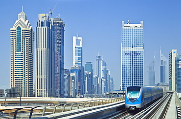 Sheikh Zayed Road skyline of high rise buildings and skyscrapers, and metro train, Dubai City, United Arab Emirates, Middle East