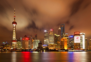 City skyline at night with Oriental Pearl Tower and Pudong skyscrapers across the Huangpu River, Shanghai, China, Asia