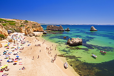 Holidaymakers sunbathing on Praia da Dona Ana, sandy beach near the resort of Lagos, Algarve, Portugal, Europe