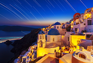 Oia village and churches with star trails after sunset, Santorini (Thira), Cyclades Islands, Greek Islands, Greece, Europe