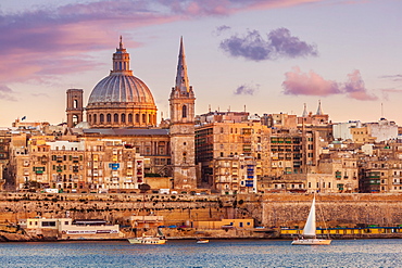 Valletta skyline at sunset with the Carmelite Church dome and St. Pauls Anglican Cathedral, Valletta, Malta, Mediterranean, Europe