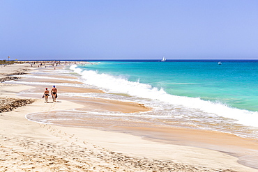 Tourists walking along the sandy beach, Ponta Preta beach, Santa Maria, Sal Island, Cape Verde, Atlantic, Africa