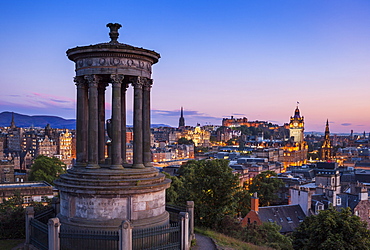 Dugald Stewart Monument, city centre and Edinburgh skyline at sunset, Calton Hill, Edinburgh, Midlothian, Scotland, United Kingdom, Europe