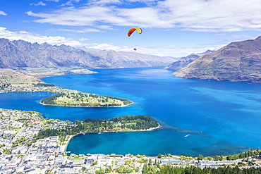 Aerial view of Queenstown, paraglider, Lake Wakatipu and The Remarkables mountains, Queenstown, Otago, South Island, New Zealand, Pacific