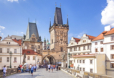 The Lesser Town Bridge Tower of Charles Bridge with people visiting the Mala Strana district, UNESCO World Heritage Site, Prague, Czech Republic, Europe