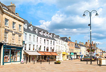 Shops and businesses on the Market Place, Cirencester town centre, Cirencester, Wiltshire, England, United Kingdom, Europe