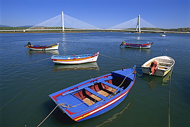 Tranquil scene of fishing boats and suspension bridge, Portimao, Algarve, Portugal, Europe