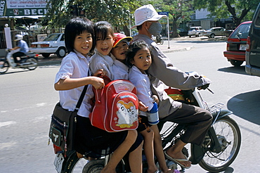 Children riding on a motor scooter, Phnom Penh, Cambodia, Indochina, Southeast Asia, Asia