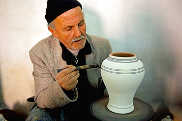 Man painting pottery vase, potters village of Safi, Atlantic coast, Morocco, North Africa, Africa