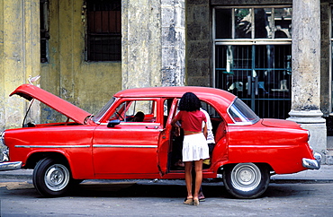 Young woman, American red car, Havana, Cuba, Central America