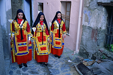 Women holding candles, Corpus Domini procession, Desulo (Gennargentu), Sardinia, Italy, Europe