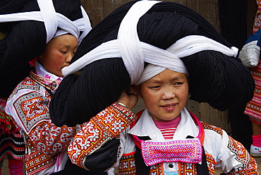 Long Horn Miao girls in traditional costumes celebrating Flower Dance Festival, Longjia village, Guizhou Province, China, Asia