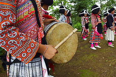 Long Horn Miao girls in traditional costumes celebrating Flower Dance Festival, Longjia village, Guizhou Province, China, Asia 