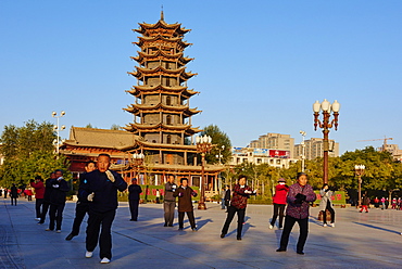 Morning exercises in front of the wooden pagoda on the main square, Zhangye, Gansu Province, China, Asia