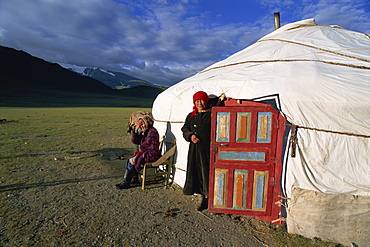 Two women outside a ger (yurt), Camp Kazakh, Khovd Gol valley, Bayan-olgii, Mongolia, Central Asia, Asia