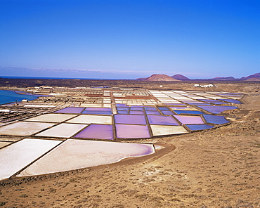 Salt pans and volcanoes in the background, near Yaiza, Lanzarote, Canary Islands, Spain, Atlantic, Europe