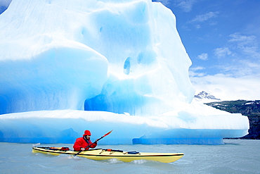 Person kayaking near floating icebergs, Lago Gray (Lake Gray), Torres del Paine National Park, Patagonian Andes, Patagonia, Chile, South America