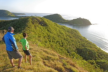 Couple viewing island beauty from the top, Drawaqa Island, Yasawa island group, Fiji, South Pacific islands, Pacific