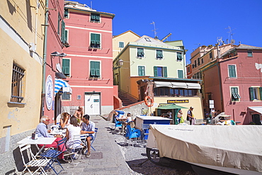 People dining at cafe in Boccadasse fishing village, Genoa, Liguria, Italy, Europe