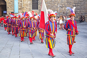 Men marching in costume during Calcio Storico Fiorentino festival at Piazza della Signoria in Florence, Tuscany, Italy, Europe