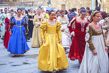 Women marching in costume dresses during Calcio Storico Fiorentino festival at Piazza della Signoria in Florence, Tuscany, Italy, Europe