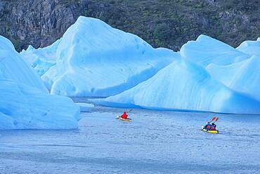 Kayakers paddles among icebergs, Torres del Paine National Park, Patagonia, Chile, South America