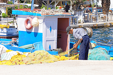 Fisherman working, Livadi, Serifos Island, Cyclades, Greek Islands, Greece, Europe