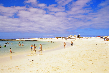 People playing on the beach and natural swimming pool beyond, near El Cotillo, Fuerteventura, Canary Islands, Spain, Atlantic Ocean, Europe