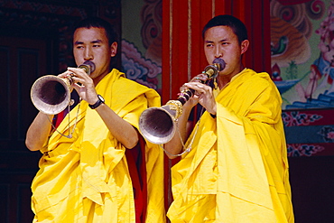 Monks blowing flutes outside a gompa (Tibetan monastery), Bodhnath, Katmandu, Nepal