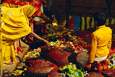 Hindus praying and giving offerings to a giant statue of Vishnu, the only image of this God in NepalBudhanilkantha, near Katmandu, Nepal