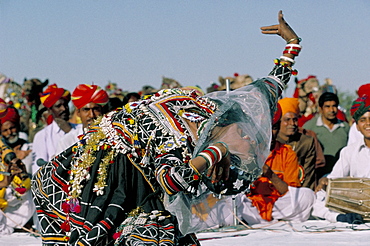 Woman dancing during desert festival, Bikaner Desert Festival, Rajasthan state, India, Asia