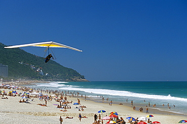 Hang-glider landing on Pepino beach, Rio de Janeiro, Brazil, South America