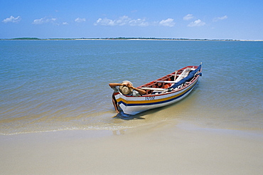 Fisherman resting on his boat, Parque Nacional dos Lencois Maranhenses, Brazil, South America