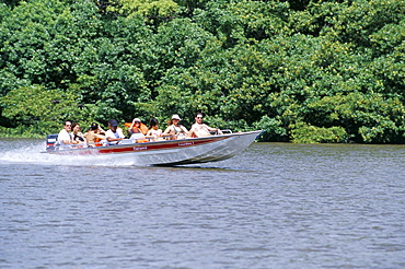 Tourists in speed boat riding on Rio Preguica, Parque Nacional dos Lencois Maranhenses, Barreirinhas, Lencois Maranhenses, Brazil, South America