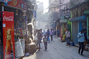 Pedestrians in north central Kolkata (Calcutta) back street showing contaminated city air, Kolkata, West Bengal, India, Asia