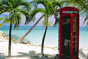 English telephone box on the beach, Dickenson's Bay, North-East coast, Antigua, West Indies 