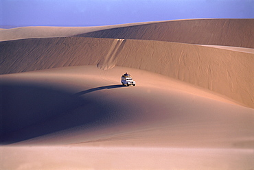 Landrover crossing sand dunes, Namib desert, Namibia