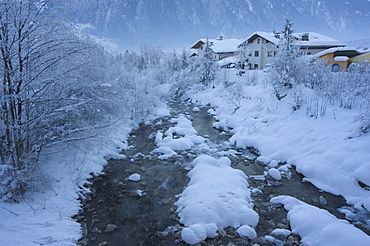 Snow covered river and houses, Mayrhofen ski resort, Zillertal Valley, Austrian Tyrol, Austria, Europe 