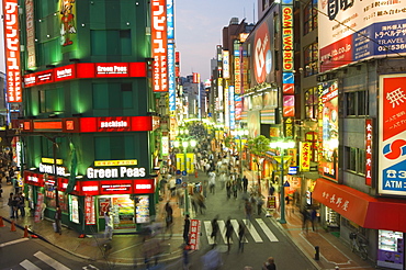 Busy streets and neon signs in the evening at Shinjuku station, Shinjuku, Tokyo, Japan, Asia