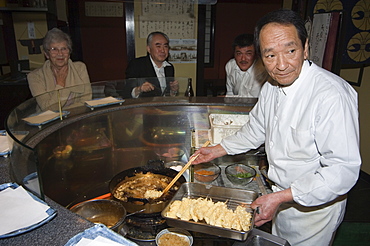 Chef cooking at tempura restaurant, Japan, Asia