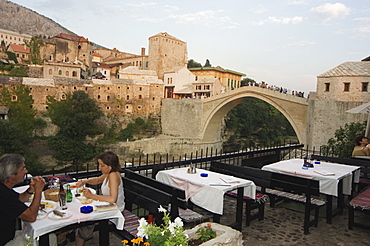 Restaurant overlooking the Stari Most Peace Bridge on Neretva River, Mostar, Bosnia, Bosnia-Herzegovina, Europe