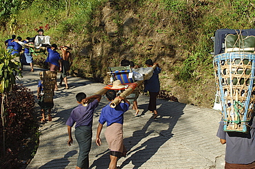 Carrying tourists/pilgrims to the Golden Rock, Golden Rock, Kyaiktiyo, Myanmar (Burma), Asia